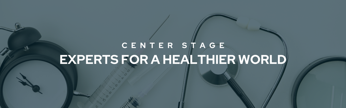 Banner that reads "Center Stage Experts For A Healthier World" in bold white text. In the dark transparent background are a variety of medical tools.