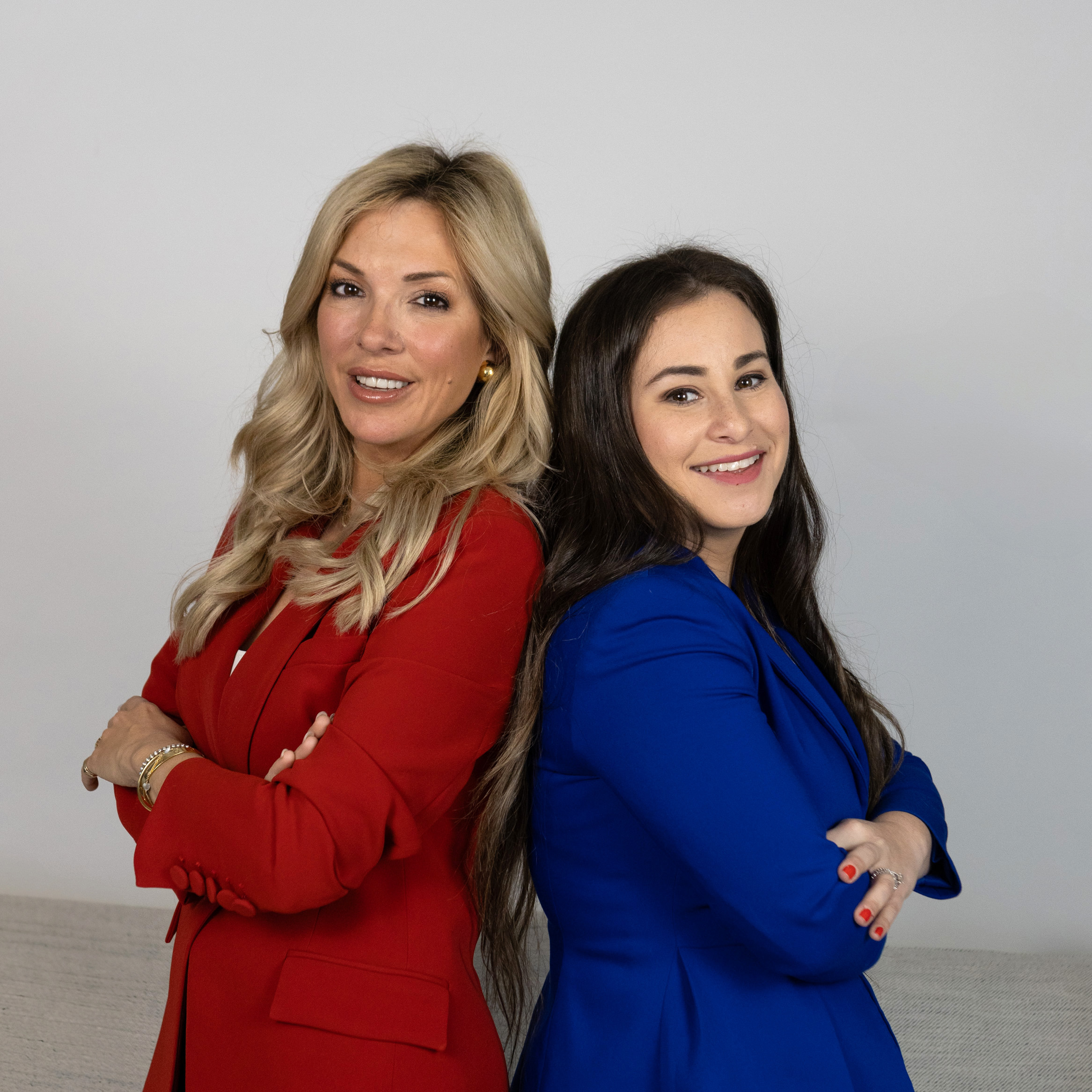 Beyond A Ballot. Headshot photo of podcast hosts, Amanda Alvaro and Rachael Segal, standing back to back and smiling.
