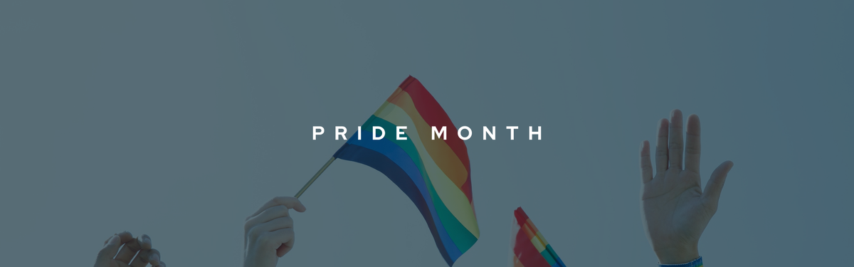Decorative banner to celebrate Pride Month and LGBTQ2S+ speakers in Canada. The title "PRIDE MONTH" is shown in the centre in bold, white font. The background shows hands raised up with 2 rainbow pride flags being waved through the air.