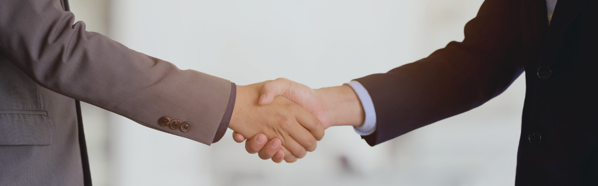 Decorative banner to depict "negoClose up on two people shaking hands.